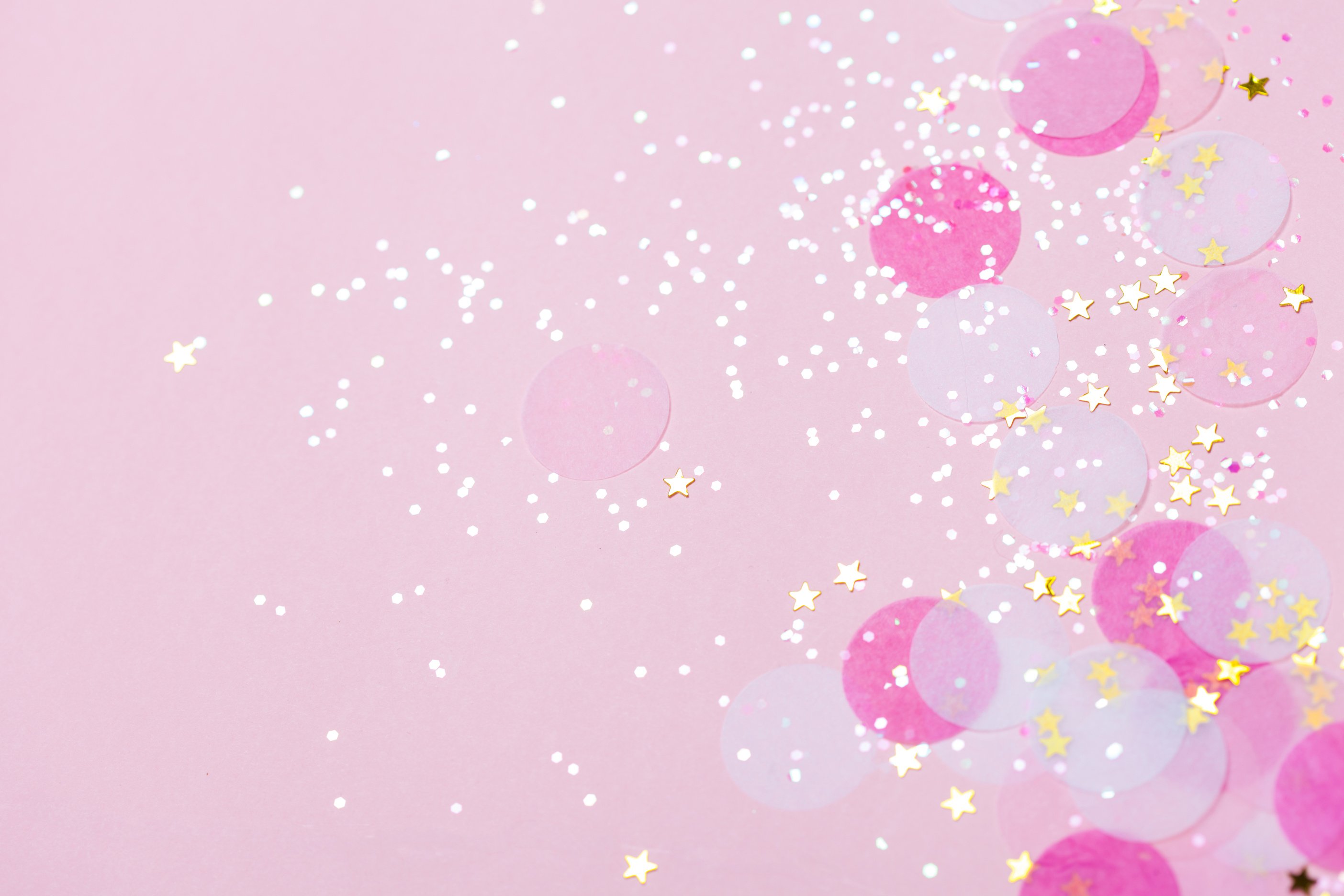 Pink pastel confetti and sparkles background.